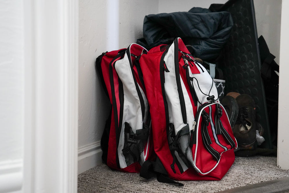 Blue Coolers - Blue Seventy-Two PRO SERIES - Deluxe 3 Day Emergency Kit for 1 Person - Red and White Example Against Wall